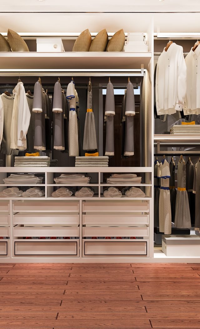 Backlit walk-in wardrobe with open shelving and drawer units