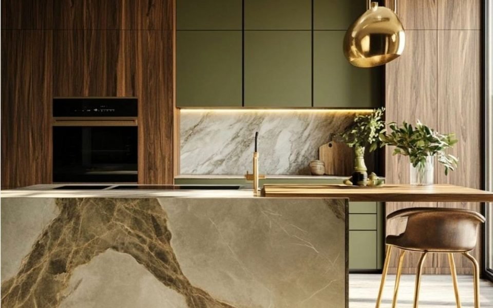 Renovated luxury kitchen in olive green with a stone waterfall island
